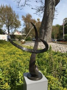 Bronze armillary sphere sundial sculpture in landscaped hotel garden setting at St Pierre Park Guernsey