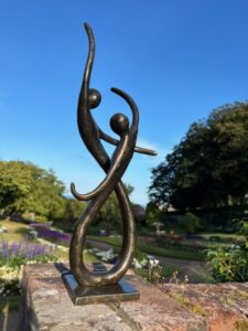 Dancing couple bronze sculpture with abstract figures in flowing modern design