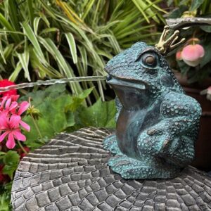 Whimsical bronze Frog Prince water feature with gold crown and flowing fountain.