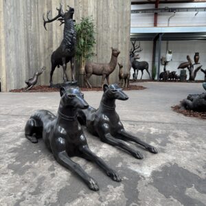 Pair of lifesize bronze guard dog sculptures in deep brown patina positioned on entrance pillars as estate sentinel statues