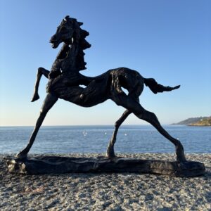 High Step Horse Bronze Equine Modern Animal Art Sculpture MO 32 – full side view with raised foreleg by the sea