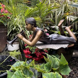 Trumpet Girl Bronze Fountain Garden Water Feature 72cm FIGI 61 complete sculpture view set within a tropical garden, combining playful character with a functioning water feature.