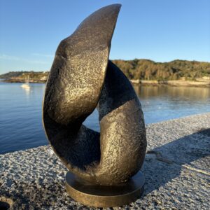 Abstract Bronze Modern Art Textured Sculpture Wave 55cm MO 8 reverse angle with sweeping curves framed by the coastal view
