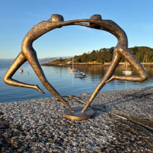 Love You Inside Out abstract bronze sculpture photographed at sunrise overlooking Havelet Bay, St Peter Port, Guernsey.