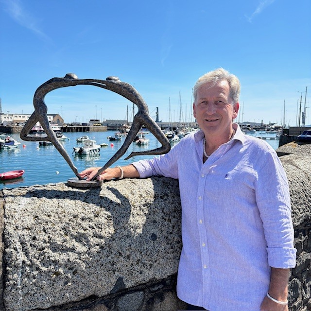 Love You Inside Out Bronze Sculpture photographed with Nick Martel overlooking St Peter Port Harbour in Guernsey