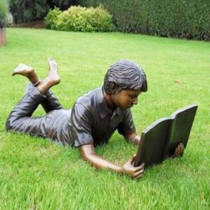 Young Student Boy Lying Down Reading Book Bronze Sculpture FIBO 2 4 | Avant Garden Bronzes