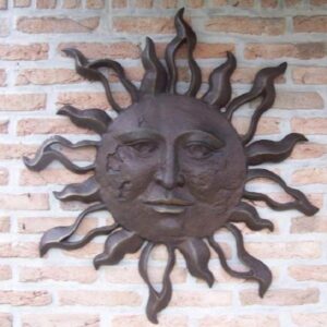 Large solid bronze sunface wall art sculpture with rich brown patina mounted as a statement garden wall feature