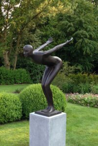Bronze Man Swimmer Frederick modern abstract sculpture positioned beside a pool