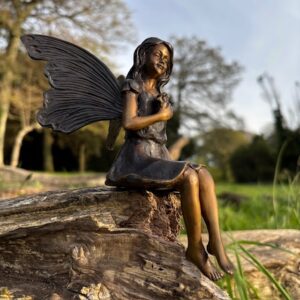 Enchanted garden fairy bronze sculpture sitting on log with wings outdoor ornament gift