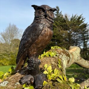 Bronze Long Eared Owl Sculpture perched on branch with detailed feathers and brown bronze finish for garden or interior.