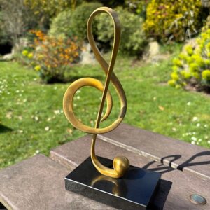 Golden musical note bronze sculpture treble clef ornament on rectangular base