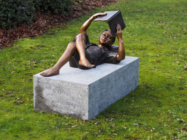 Student Boy Lying Back Reading A Book Bronze Sculpture FIBO 57 1 | Avant Garden Bronzes