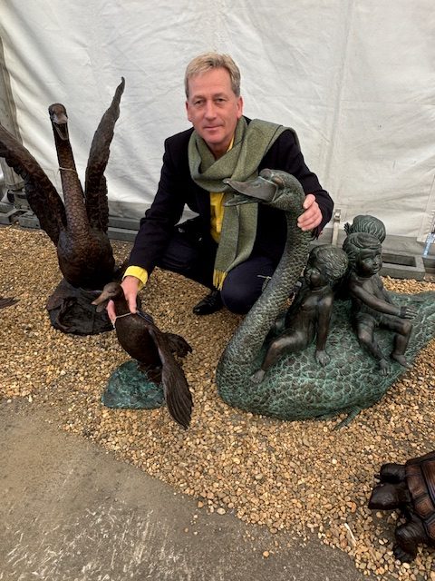 Three putti riding a swan bronze fountain water feature with classical verdigris finish