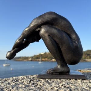 Bronze Diving Man Sculpture FIME 28 low angle view highlighting the athletic crouched figure