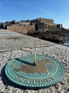 26cm solid bronze flat sundial with Roman numerals and verdigris finish designed for pedestal or stone garden placement
