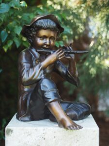 Bronze Boy Playing Flute Fountain featuring a young musician in solid bronze with integrated garden water feature.