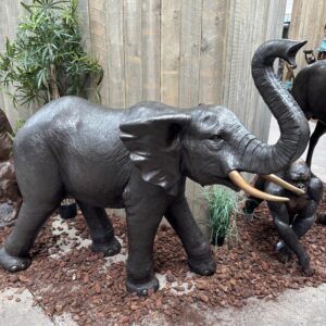 Bronze lifesize imperial elephant sculpture side view showing full body, raised trunk and tusks, large outdoor garden statement piece