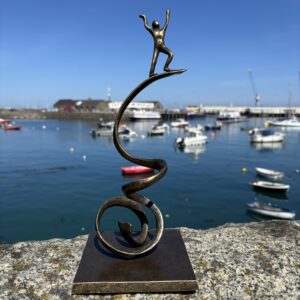 Bronze Triumph Balance Sculpture modern bronze desk sculpture with sweeping curved design and raised figure