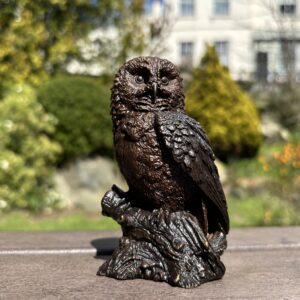 Bronze Woodland Sentinel Owl Sculpture angled front view on rustic branch natural garden background
