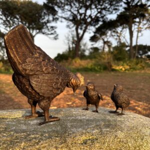 Bronze Hen and Chicks Garden Sculpture Set on stone with mother hen and two chicks facing each other