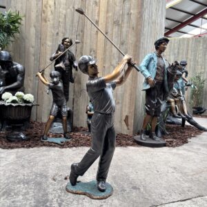 The Young Champion – Bronze Boy Golfer Sculpture FIME 46 front three quarter view showing confident follow through with detailed figure and club positioning