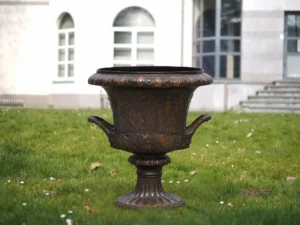 The Classical Heritage Bronze Urn Vase MESU 135 large decorative bronze garden urn with classical relief figures and ornate handles displayed on a lawn