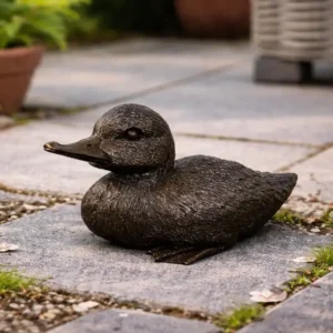 Bronze Duck Garden Sculpture BI 119 resting on a stone garden path