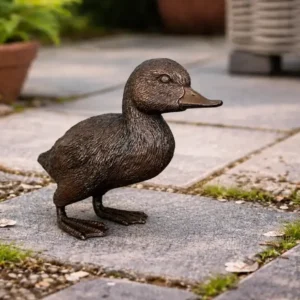 Bronze Standing Duck Garden Sculpture BI 120 standing on a stone garden path