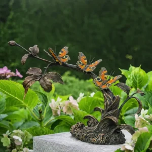 Butterflies on Blossom Branch Bronze Sculpture MI 137 displayed amongst summer flowers.