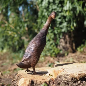 Elegant standing duck bronze garden sculpture displayed outdoors in a natural woodland setting